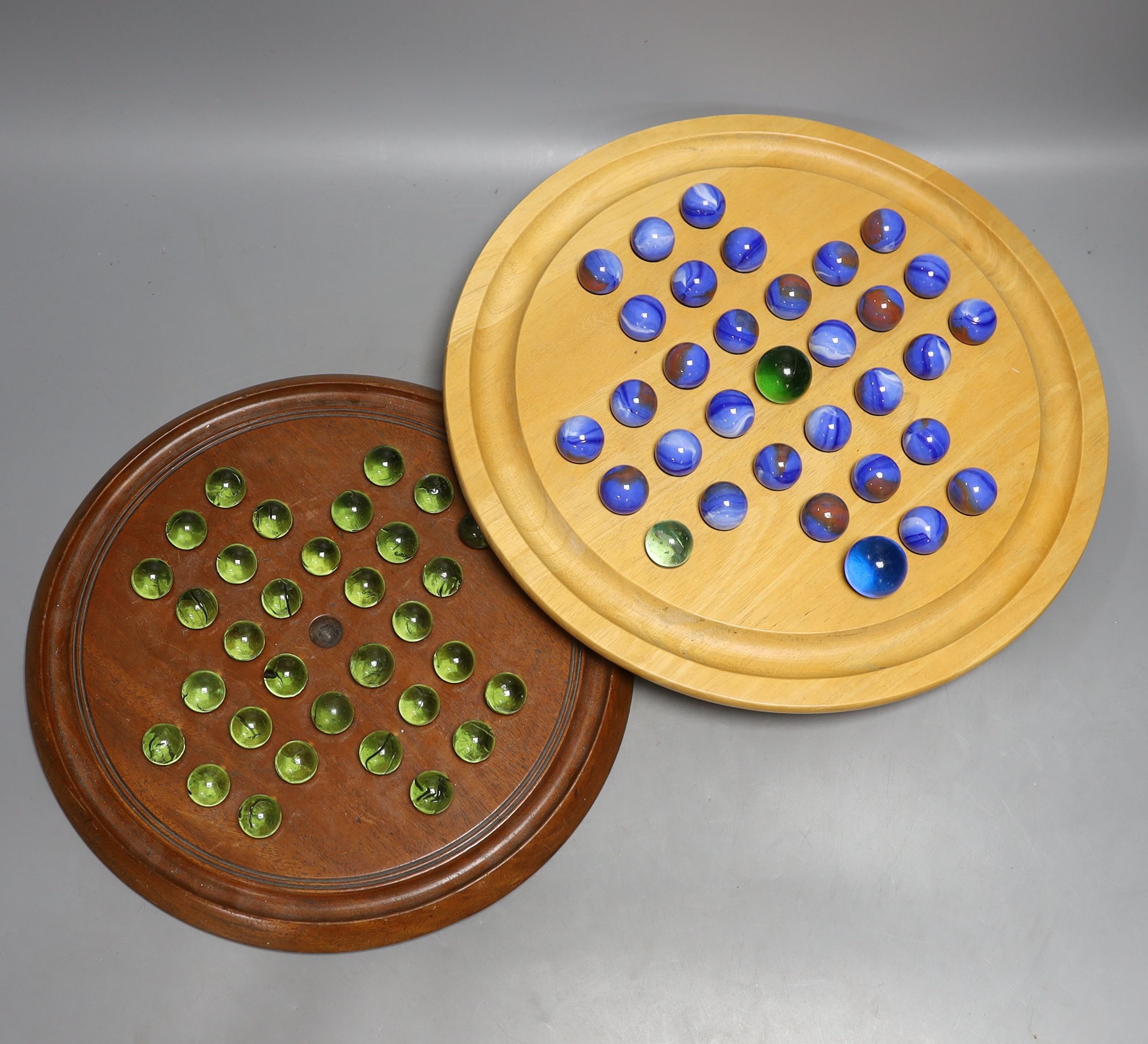 Two solitaire sets, largest 35 cms diameter.